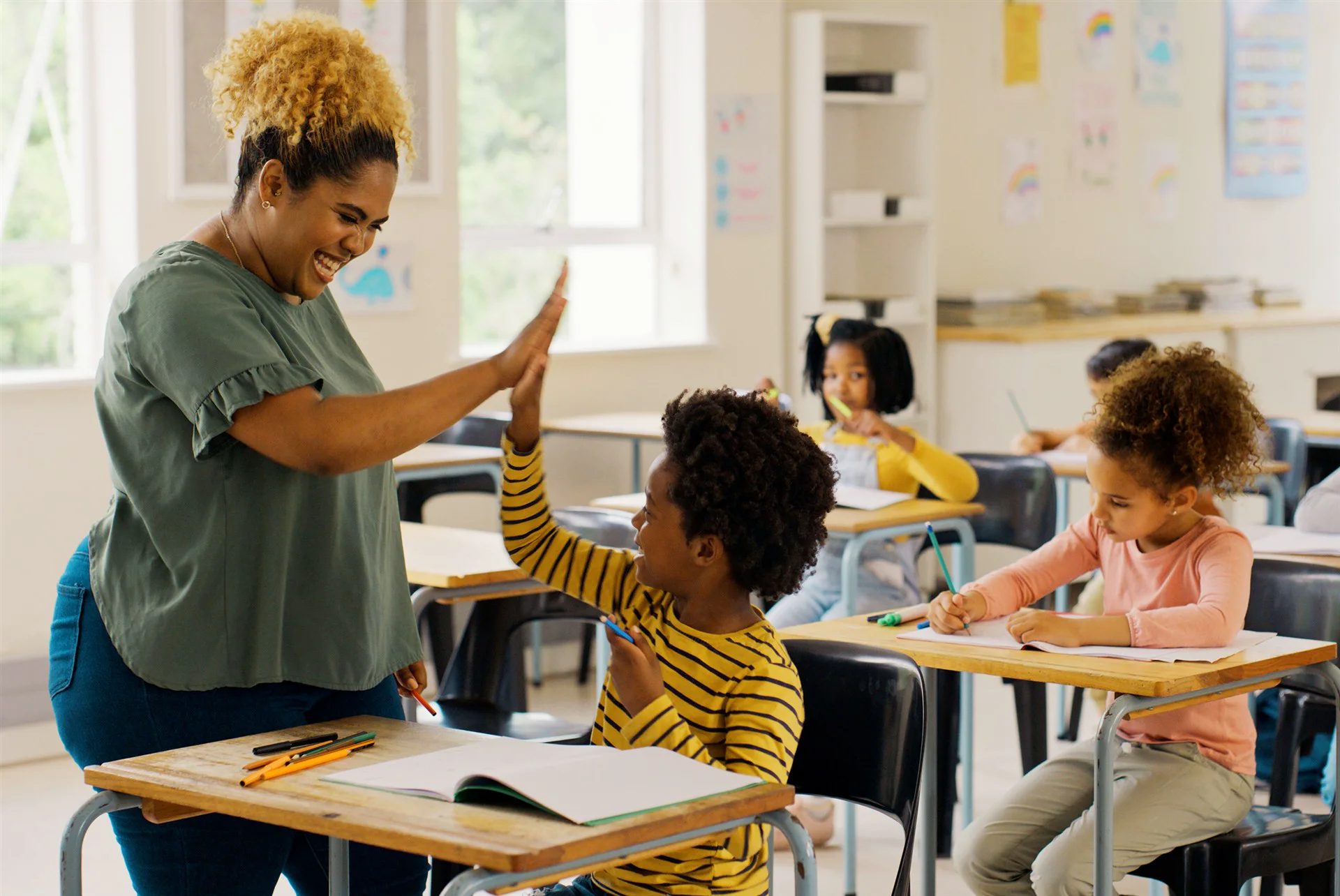 A student high-fiving an educator