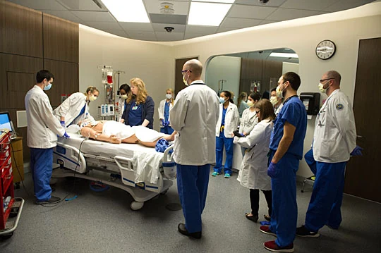 Illustrative photograph of a medical team gathered around a hospital bed