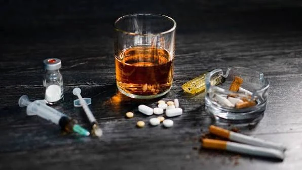 Awareness photograph showing alcohol, cigarettes, pills, and syringes